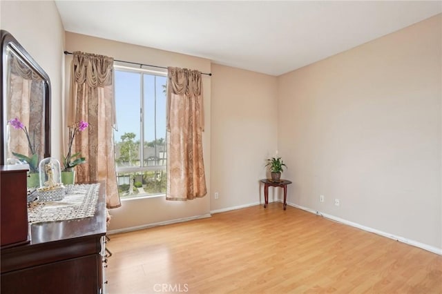 sitting room featuring baseboards and wood finished floors