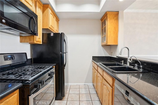 kitchen featuring black microwave, dishwashing machine, dark stone counters, stainless steel range with gas stovetop, and a sink