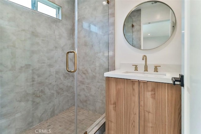 bathroom with vanity and a stall shower