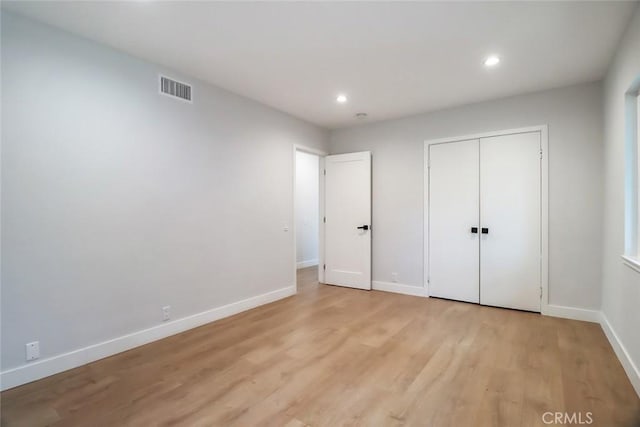 unfurnished bedroom with recessed lighting, baseboards, light wood finished floors, and visible vents
