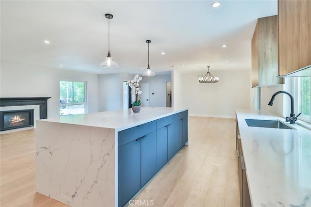 kitchen featuring a sink, light wood finished floors, and open floor plan