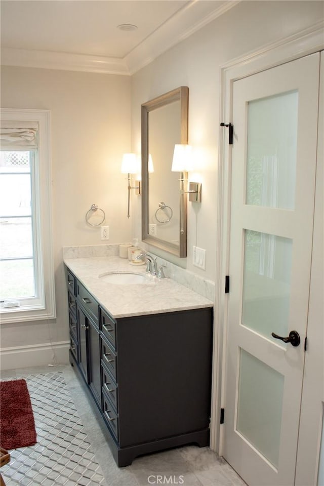 bathroom with vanity and ornamental molding