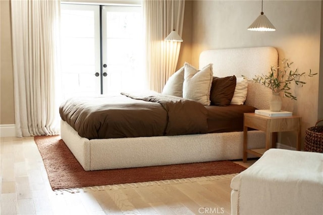 bedroom featuring multiple windows and wood finished floors
