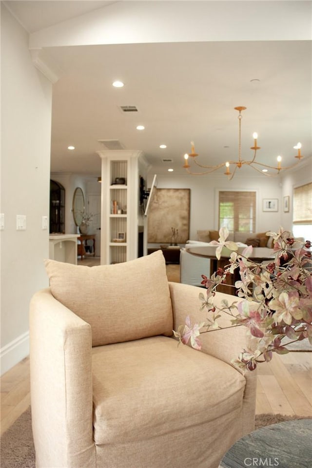 living area with visible vents, an inviting chandelier, wood finished floors, baseboards, and recessed lighting