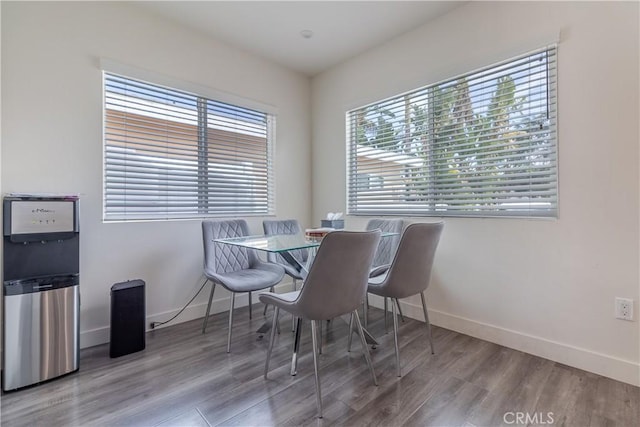 dining area featuring baseboards and wood finished floors