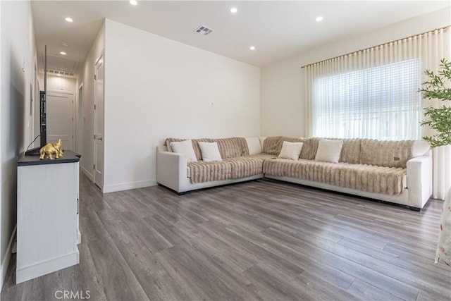 living area featuring recessed lighting, wood finished floors, and visible vents