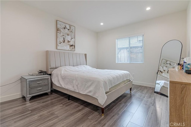 bedroom with baseboards, recessed lighting, and wood finished floors