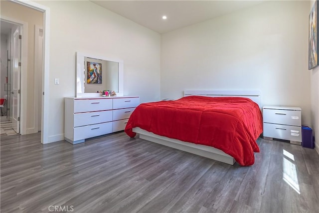 bedroom with recessed lighting, baseboards, and wood finished floors