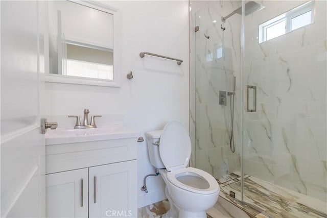 bathroom with vanity, baseboards, toilet, and a marble finish shower