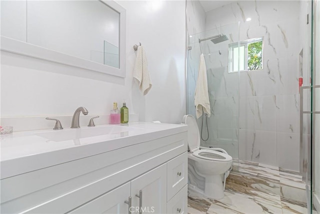 full bathroom with vanity, marble finish floor, a marble finish shower, and toilet