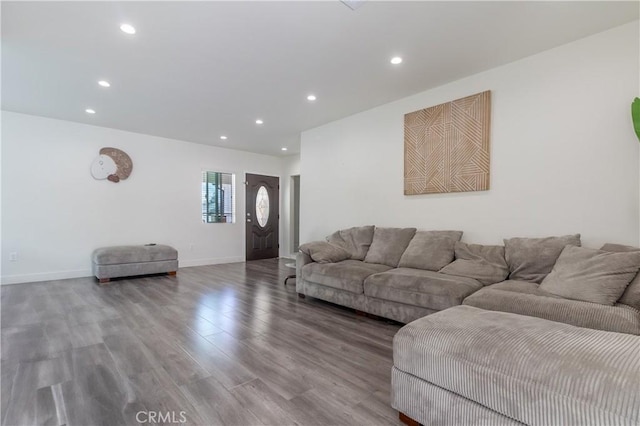 living room featuring recessed lighting, baseboards, and wood finished floors