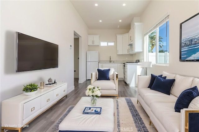 living area with recessed lighting and wood finished floors