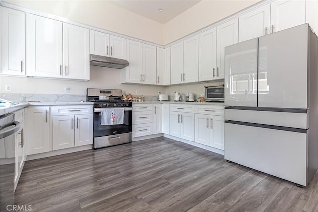 kitchen featuring light stone counters, white cabinets, under cabinet range hood, stainless steel appliances, and dark wood-type flooring