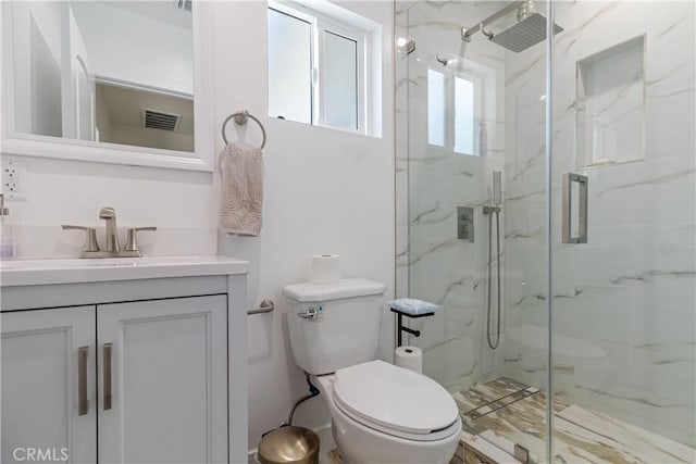 full bathroom featuring toilet, visible vents, a marble finish shower, and vanity