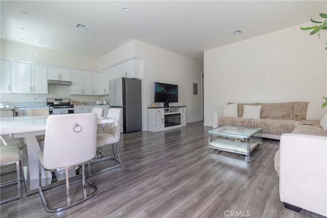 living room featuring visible vents and wood finished floors