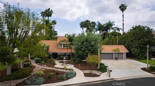 11080 Kayjay St, Riverside, CA 92503 - view of front of house featuring a tile roof, concrete driveway, a garage, and stucco siding