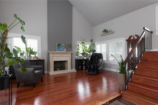 11080 Kayjay St, Riverside, CA 92503 - living room featuring high vaulted ceiling, stairway, wood finished floors, baseboards, and a high end fireplace