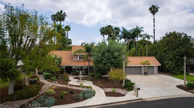 11080 Kayjay St, Riverside, CA 92503 - view of front facade with a tiled roof, driveway, a garage, and stucco siding