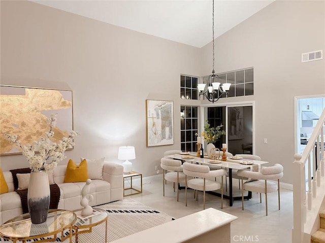 dining room featuring a notable chandelier, high vaulted ceiling, stairs, baseboards, and visible vents