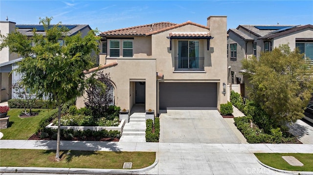 mediterranean / spanish house featuring a garage, stucco siding, a chimney, concrete driveway, and a tile roof