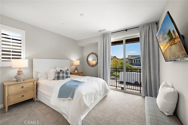 carpeted bedroom with access to outside and visible vents