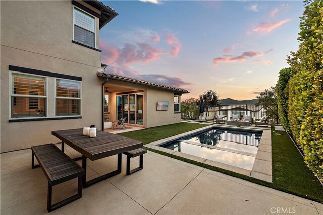 pool featuring a fenced backyard, a patio, and outdoor dining area