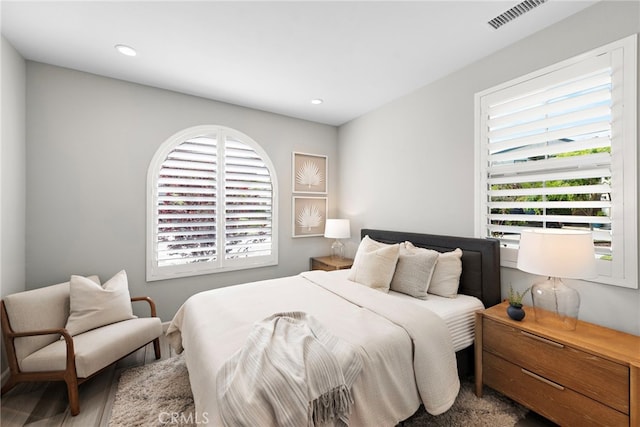 bedroom featuring visible vents, recessed lighting, and multiple windows