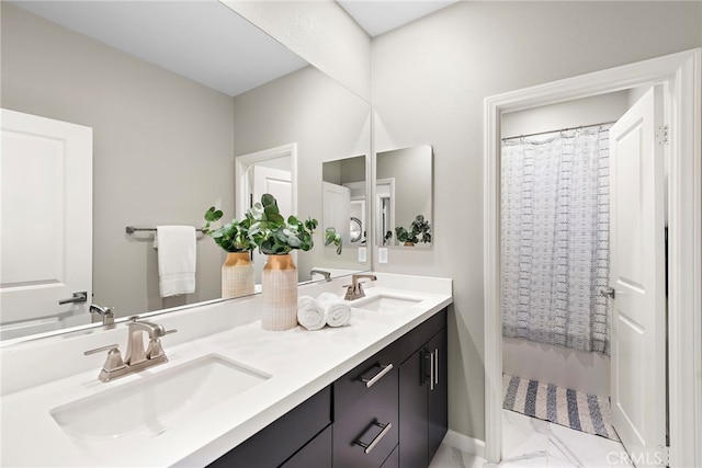 bathroom with double vanity, a sink, and marble finish floor