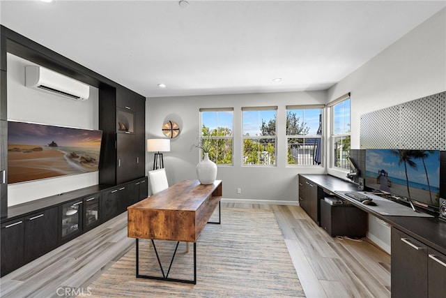 office with recessed lighting, baseboards, an AC wall unit, and light wood-type flooring