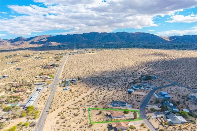 birds eye view of property with a rural view, a mountain view, and view of desert