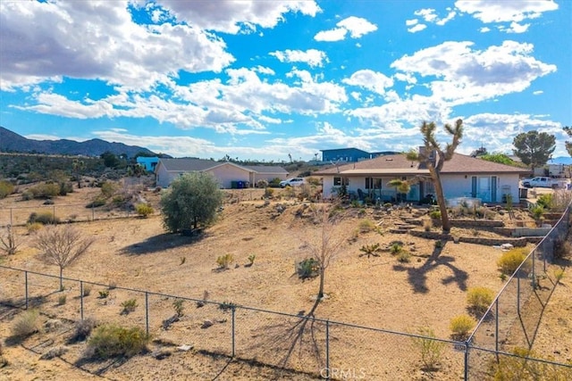 exterior space featuring fence and a mountain view