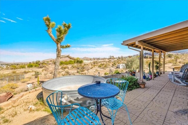 view of patio / terrace with fence and view of desert