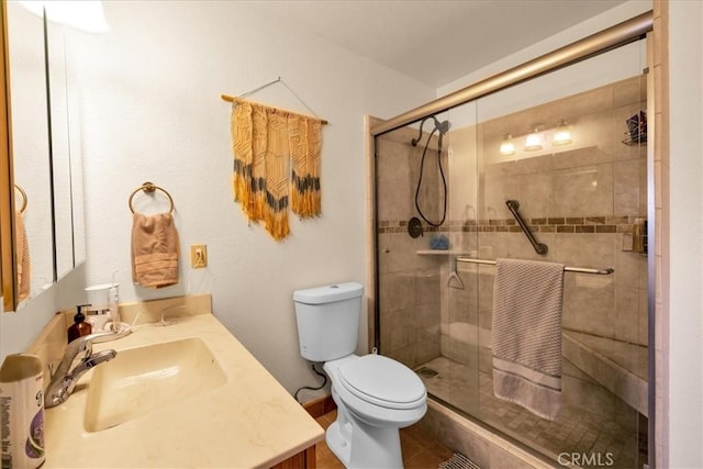 full bath with vanity, tile patterned floors, a stall shower, and toilet