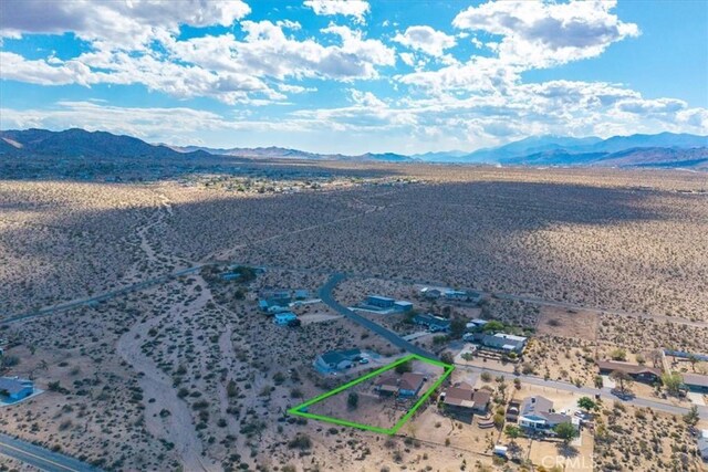 bird's eye view featuring a rural view, a mountain view, and a desert view