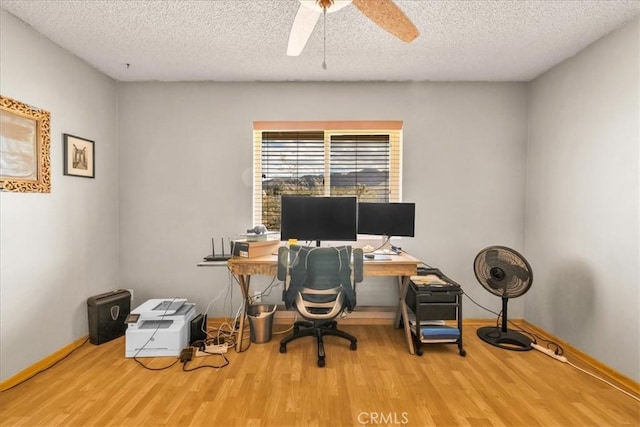 office area with baseboards, a textured ceiling, ceiling fan, and wood finished floors