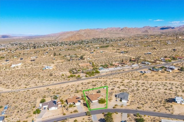 birds eye view of property featuring a rural view, a mountain view, and a desert view