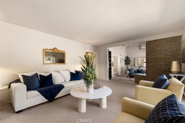 living area with carpet and ceiling fan