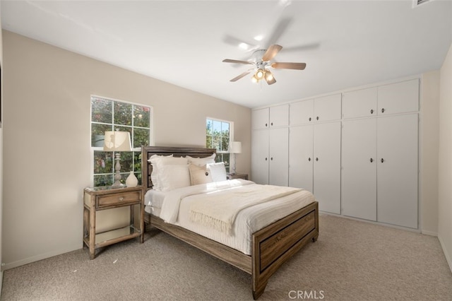 bedroom featuring baseboards, ceiling fan, and light colored carpet