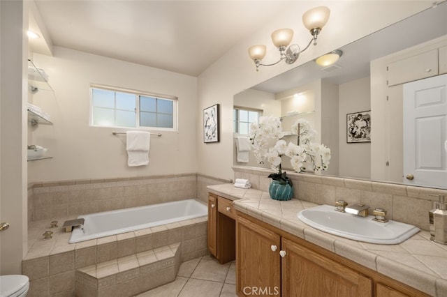 full bath with tile patterned floors, plenty of natural light, a bath, and vanity
