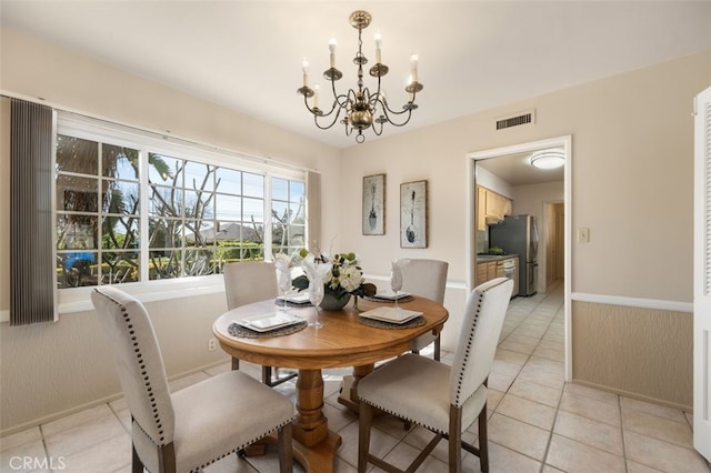 dining area with light tile patterned floors, a notable chandelier, and visible vents