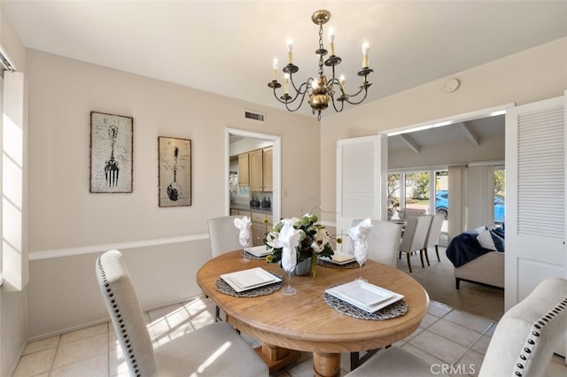 dining space featuring light tile patterned floors, visible vents, lofted ceiling with beams, and a notable chandelier