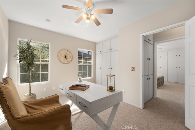 office with a ceiling fan and light colored carpet