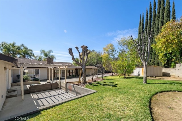 view of yard with a patio, an outbuilding, an outdoor hangout area, and a storage unit