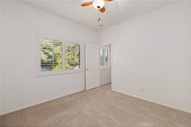 40949 Granite St, Palmdale, CA 93551 - spare room with baseboards, a ceiling fan, a healthy amount of sunlight, and light carpet