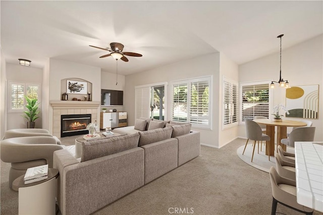 40949 Granite St, Palmdale, CA 93551 - living area featuring a tiled fireplace, baseboards, carpet, and ceiling fan with notable chandelier
