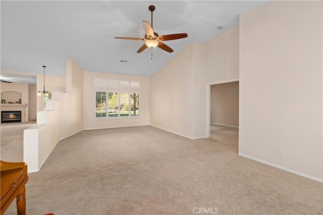 40949 Granite St, Palmdale, CA 93551 - unfurnished living room featuring carpet floors, ceiling fan, a glass covered fireplace, and high vaulted ceiling