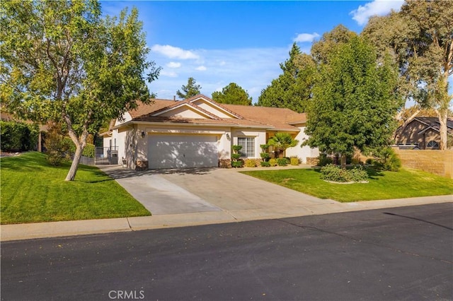 40949 Granite St, Palmdale, CA 93551 - view of front of house featuring fence, a front lawn, concrete driveway, an attached garage, and stucco siding