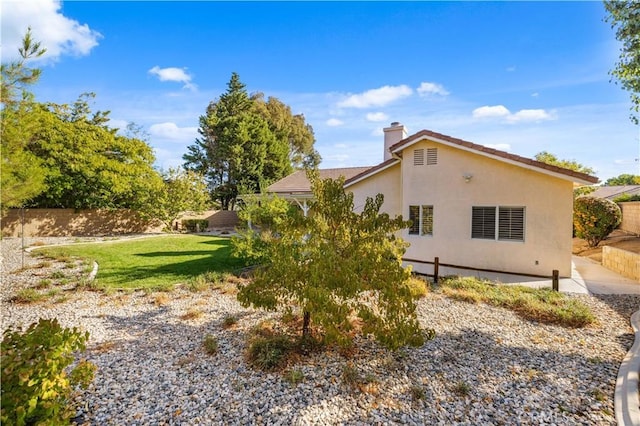 40949 Granite St, Palmdale, CA 93551 - view of side of home with a chimney and stucco siding