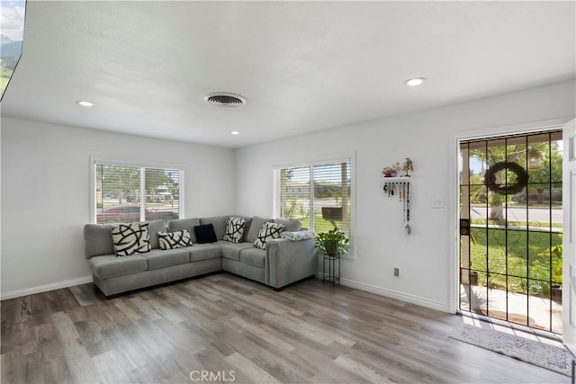 2113 Herrington Ave, San Bernardino, CA 92411 - living room featuring visible vents, plenty of natural light, and wood finished floors