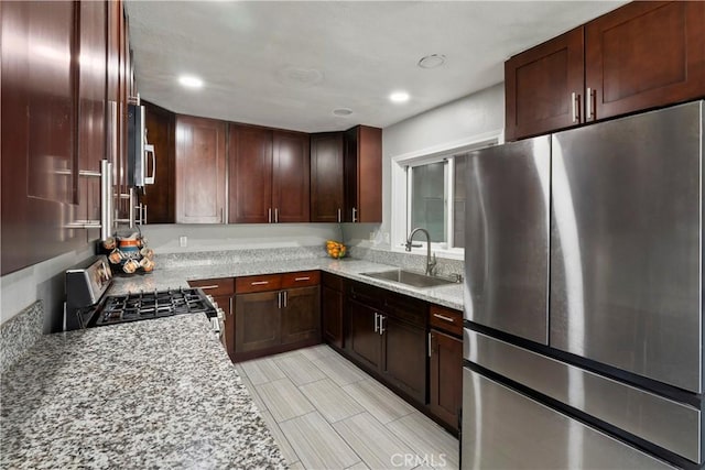 2113 Herrington Ave, San Bernardino, CA 92411 - kitchen with recessed lighting, a sink, appliances with stainless steel finishes, and light stone countertops